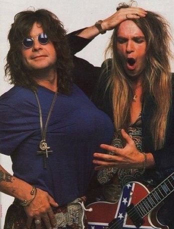 Ozzy Osbourne with long hair next to another dude with long blond hair