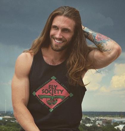 A picture of a long hair bodybuilder with a chest length hairstyle