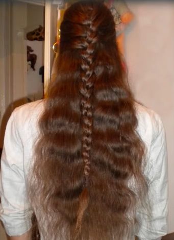 A picture of a long hair dude with a half French plait hairstyle