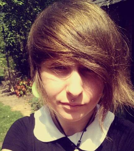 A picture of a school boy with long hair and a side fringe hairstyle