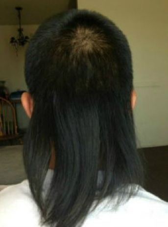 A picture of an Asian guy with the perfect skullet hair style and haircut performed at a barbershop