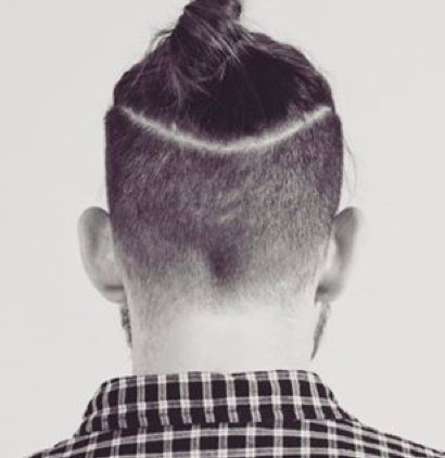 A photograph of a disconnected haircut for the top knot hairstyle illustrating the horizontal temple line of an undercut