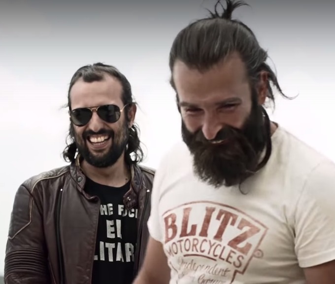A photograph of two male brothers wearing man buns and experiencing hair loss and a receding hairline from tying the knots too tight
