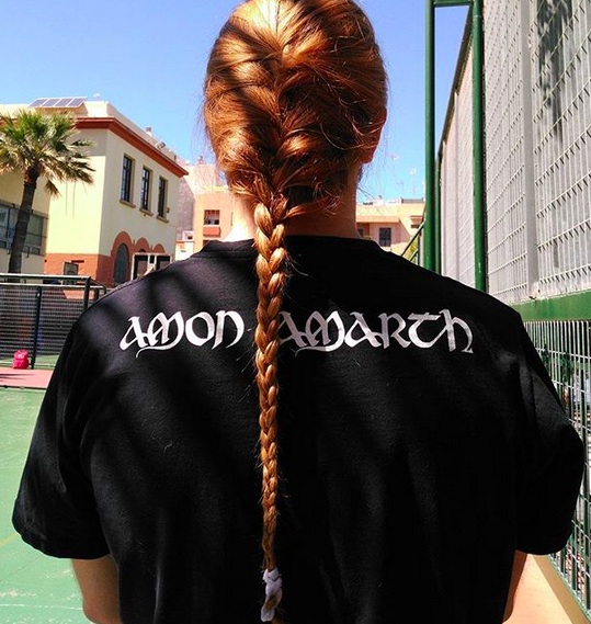 A cool picture of a redhead male with long straight hair styled into a fishbraid ponytail