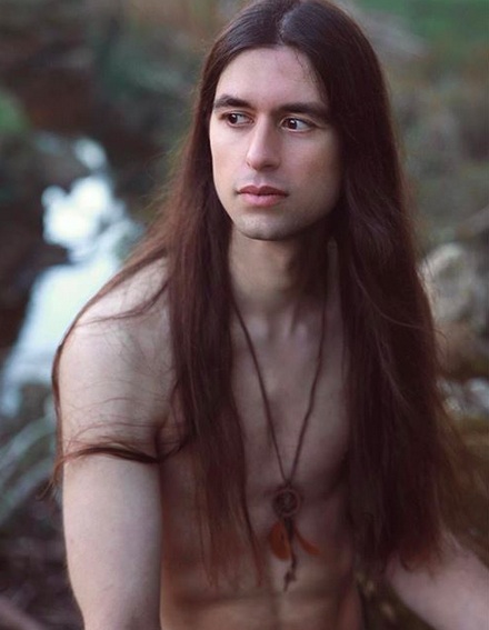 A photograph of a good-looking Native American Indian with very long straight hair that looks very healthy due to a frequent use of a hair conditioner