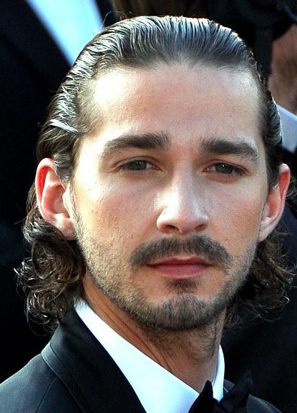 A picture of a curly Jewish male with his long hair slicked back by using a fine tooth comb