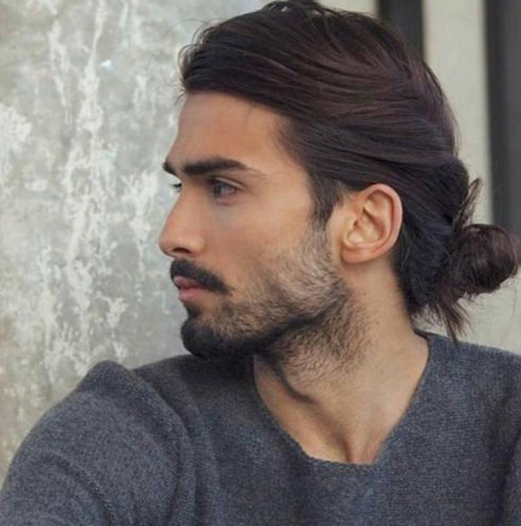 A barbershop photograph of a good-looking young Arab male with a man