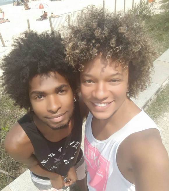 An interesting picture of two young black guys with long kinky curly hair and one of them has blonde natural curls due to his mixed-race heritage